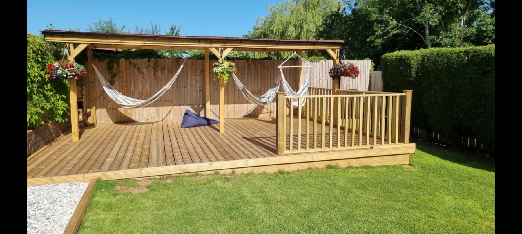 Covered timber decking and garden seating area