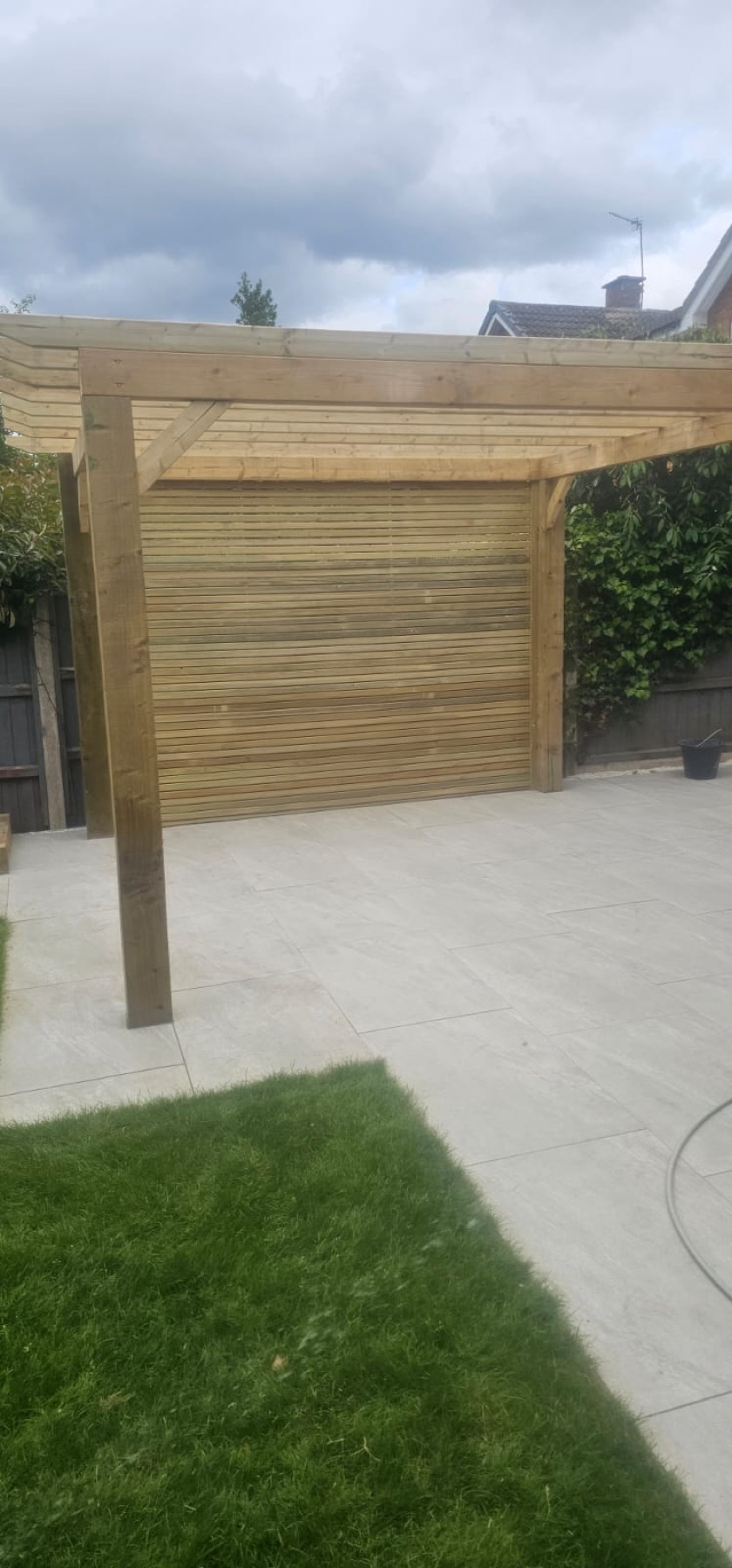 Garden pergola, paved patio and timber privacy screening