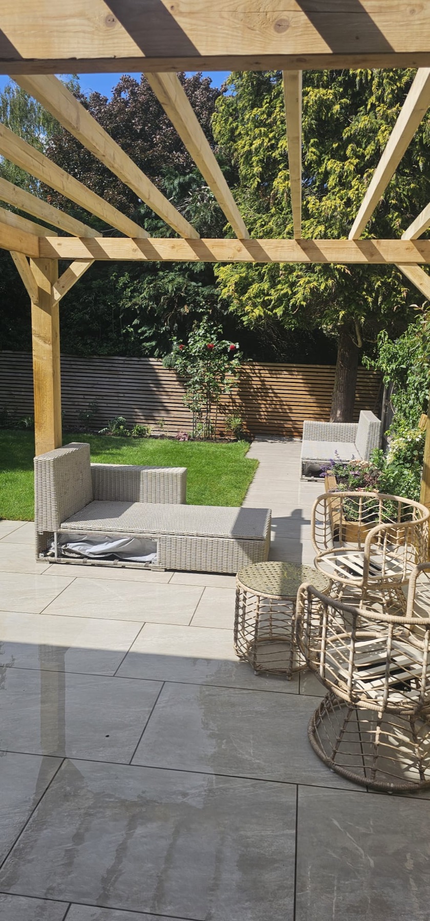 Timber pergola with horizontal slatted garden fencing