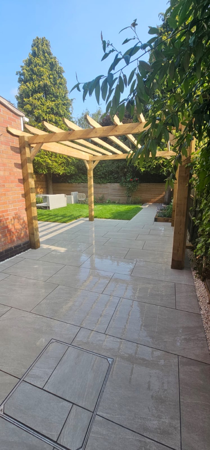 Timber pergola installed over a large paved patio